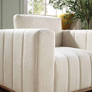 Close-up of a textured white sofa with a plant in the background